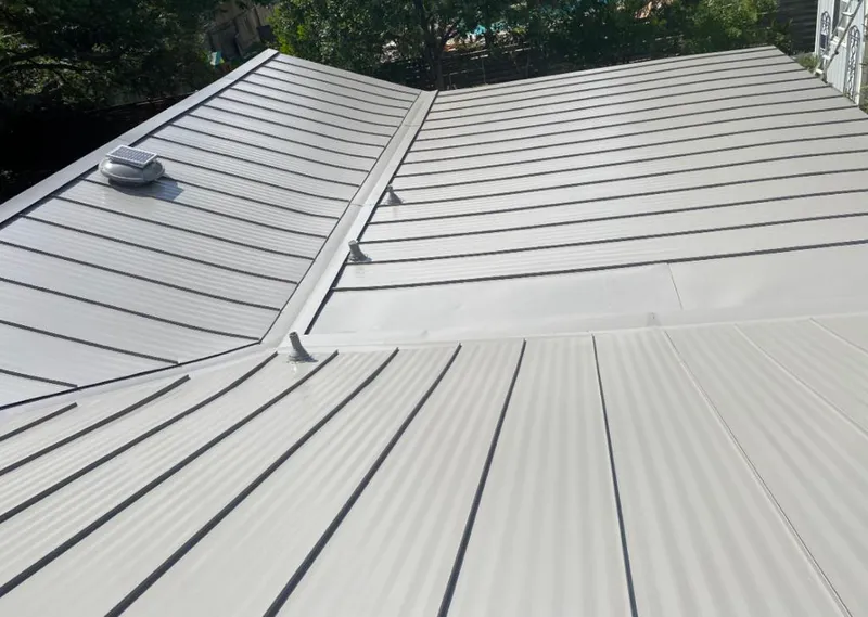 Solar attic fan installed on a metal roof for Roof Ventilation in Oak Bluffs